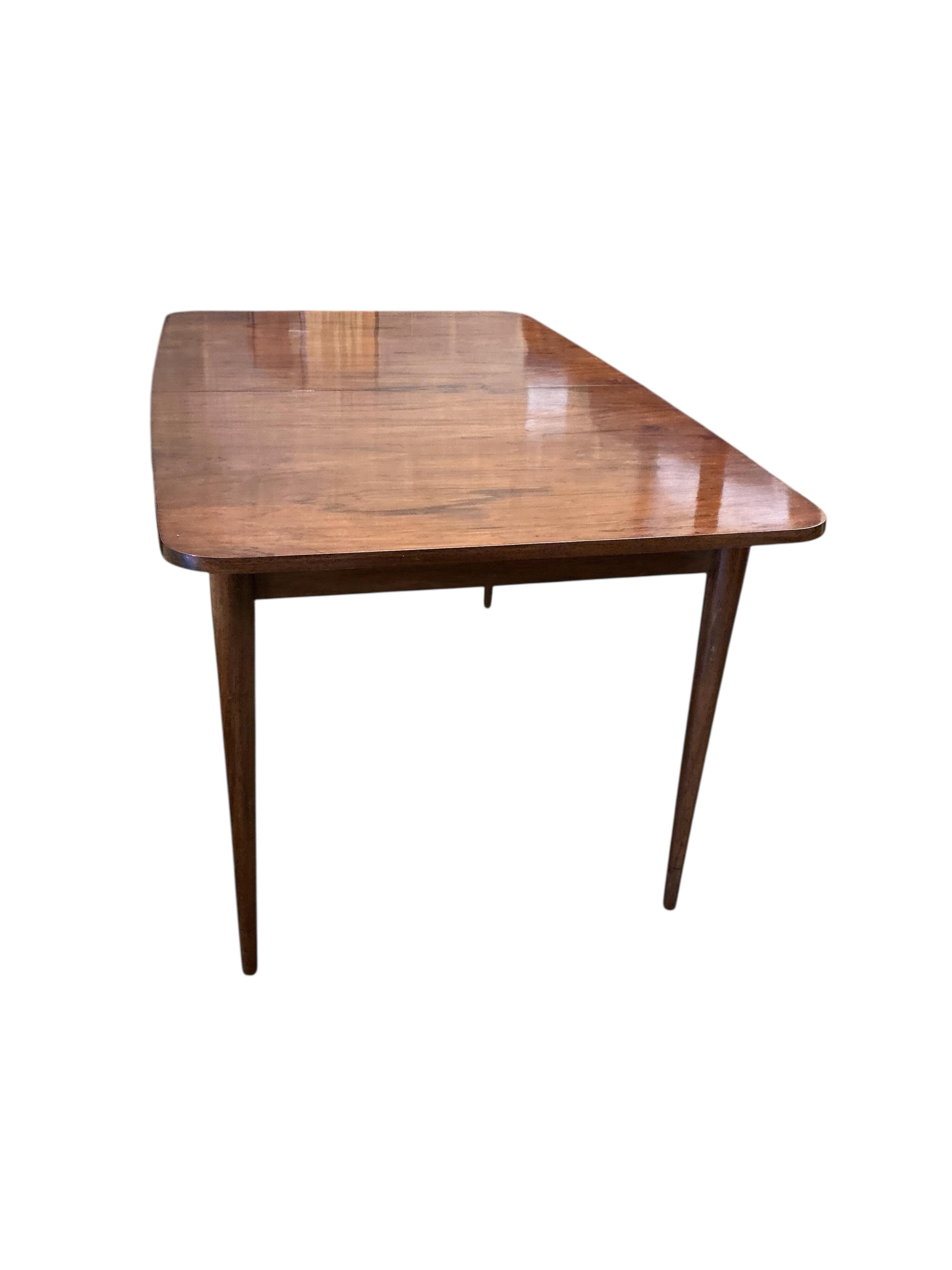 A mid century Archie Shine Indian rosewood extending dining table, width 144cm, depth 84cm, height 72cm and six upholstered chairs, two with arms